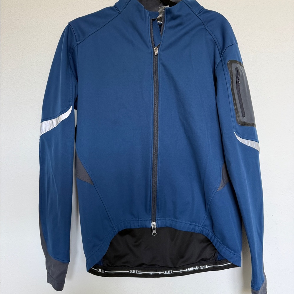 REI navy blue men's performance softshell jacket with reflective accents